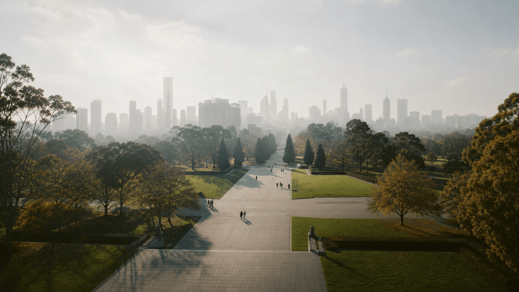 Tree-lined walkway leading toward the Melbourne skyline
